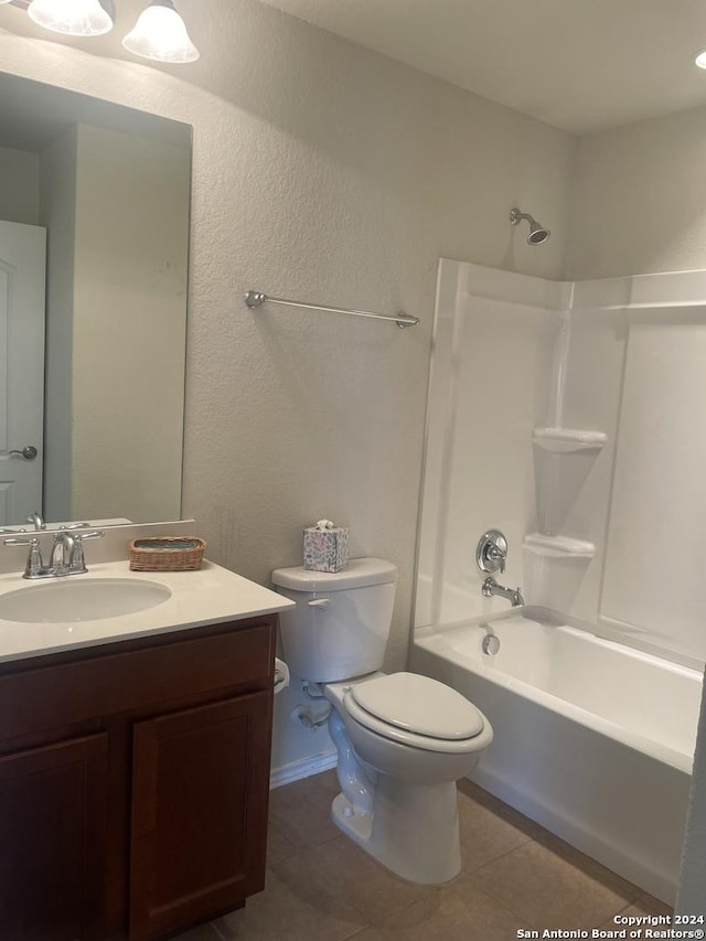 full bathroom with tile patterned flooring, vanity,  shower combination, and toilet