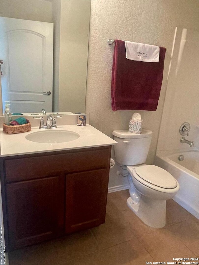 full bathroom with toilet, vanity, tile patterned floors, and tub / shower combination