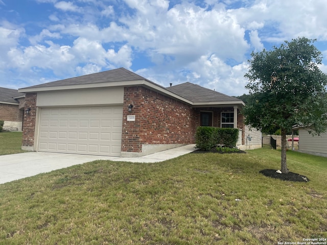 ranch-style house featuring a garage and a front lawn