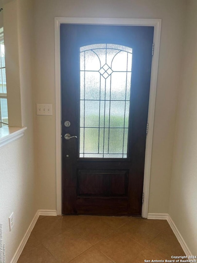 tiled foyer entrance featuring a wealth of natural light