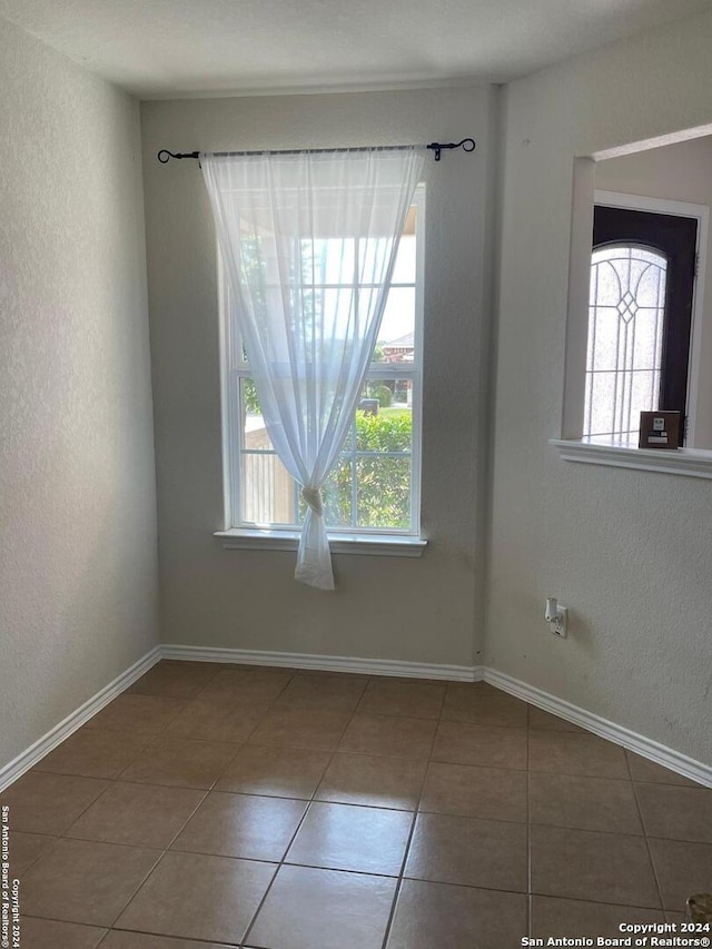 spare room with tile patterned flooring