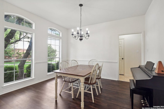 dining room featuring a notable chandelier and dark wood-type flooring