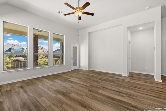 unfurnished room featuring dark wood-type flooring and ceiling fan