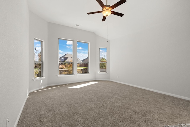 spare room featuring lofted ceiling, ceiling fan, and carpet