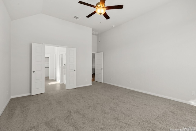 unfurnished bedroom with ceiling fan, high vaulted ceiling, a spacious closet, and carpet floors