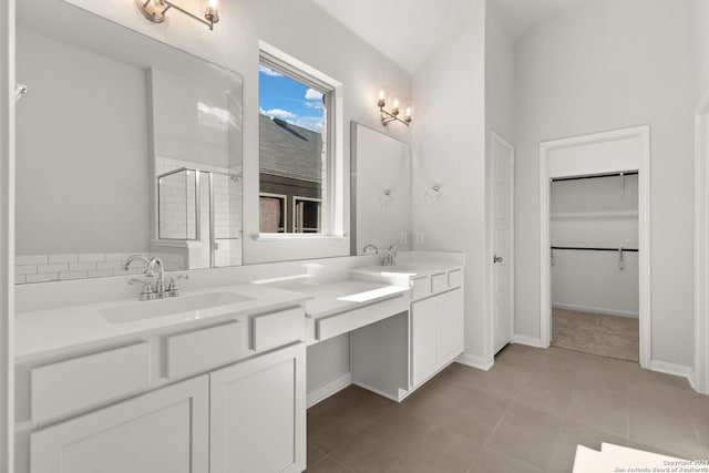 bathroom featuring tile patterned flooring, vanity, and walk in shower