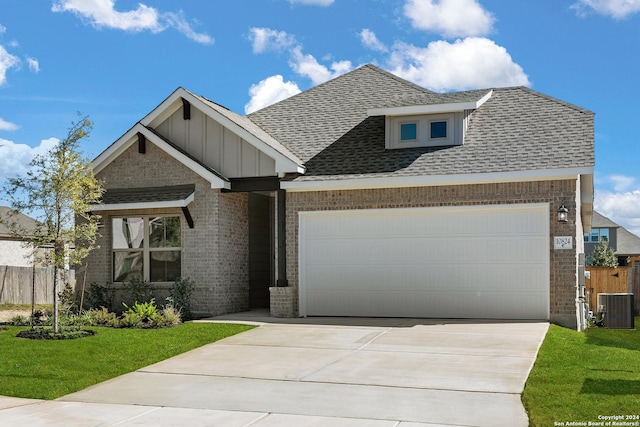 craftsman inspired home with a garage, central AC unit, and a front yard