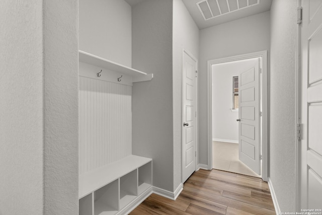 mudroom with wood-type flooring