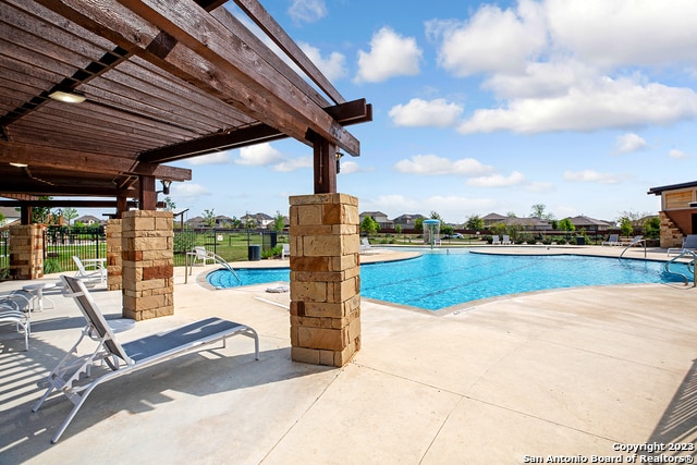 view of pool with a pergola and a patio area