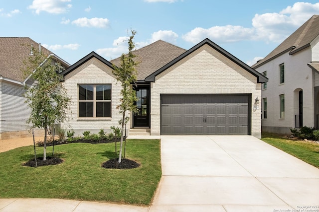 view of front of house with a garage and a front yard