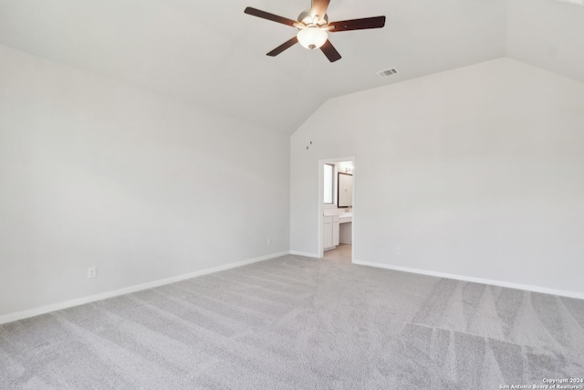 carpeted empty room featuring ceiling fan and lofted ceiling