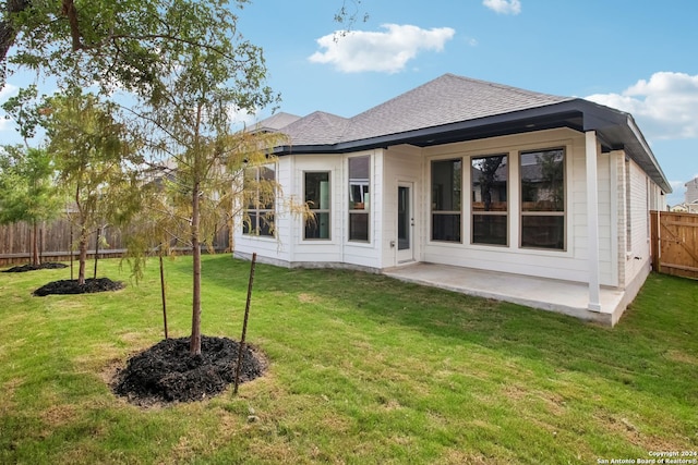 back of property featuring a yard and a patio