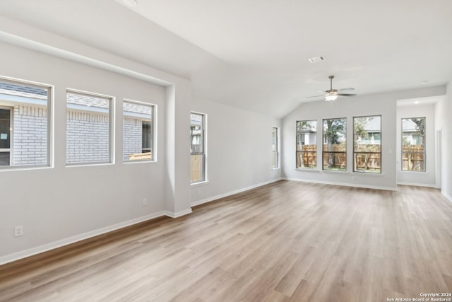 interior space with vaulted ceiling, ceiling fan, and light wood-type flooring