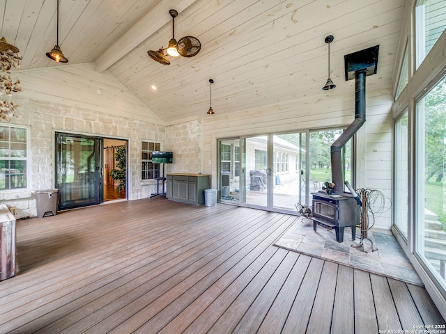 living room with ceiling fan, a stone fireplace, and lofted ceiling