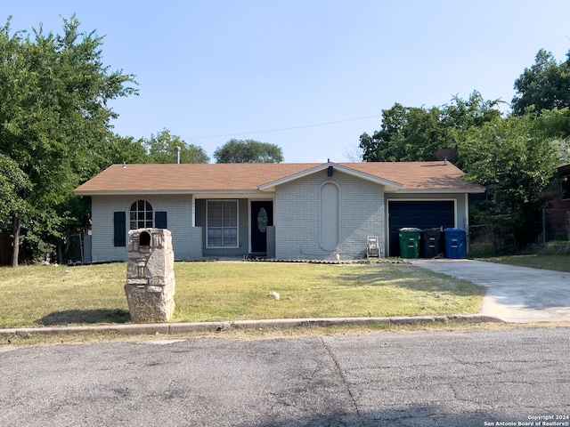 single story home with a garage and a front lawn