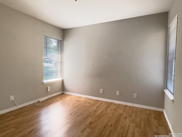 unfurnished room with hardwood / wood-style floors