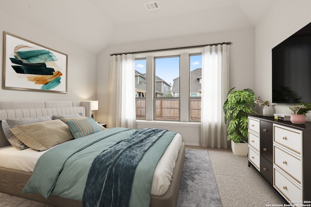 carpeted bedroom featuring lofted ceiling