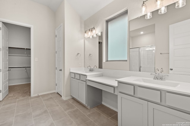 bathroom with vanity, walk in shower, and tile patterned floors