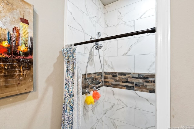 bathroom with a tile shower