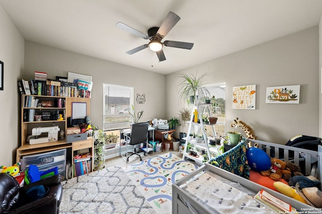 bedroom with a crib and ceiling fan