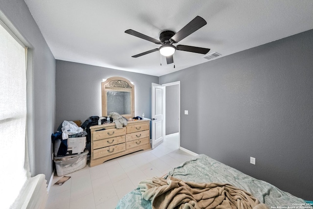 bedroom with ceiling fan and multiple windows