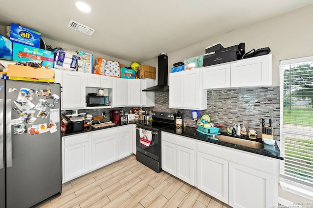 kitchen with sink, white cabinets, decorative backsplash, black appliances, and wall chimney exhaust hood