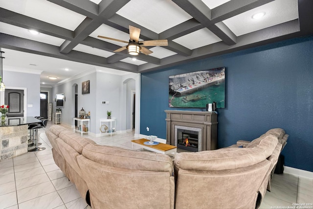 living room with coffered ceiling, beamed ceiling, ornamental molding, and light tile patterned flooring