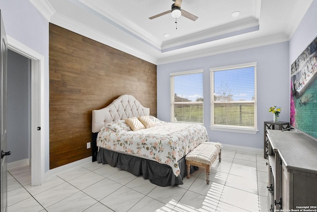 bedroom featuring ceiling fan, a raised ceiling, ornamental molding, and light tile patterned flooring