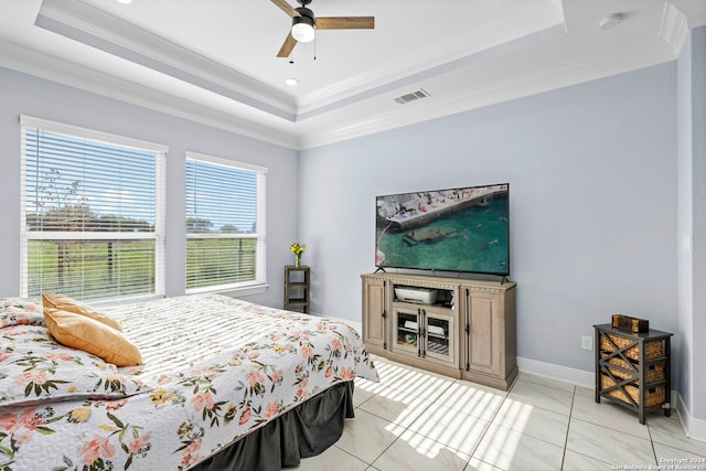 tiled bedroom with a tray ceiling, ceiling fan, and ornamental molding