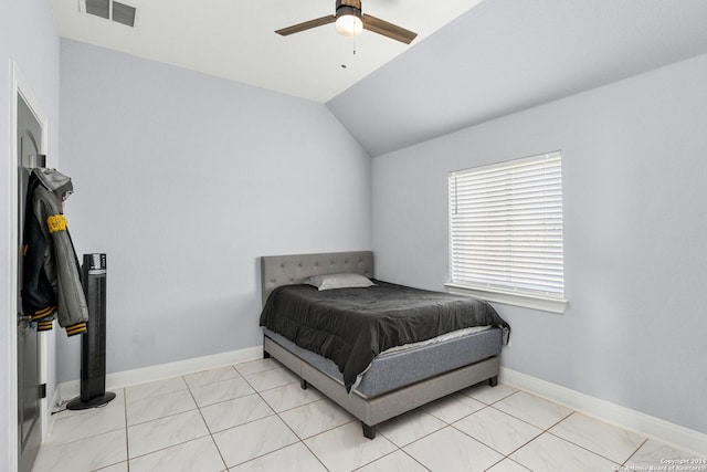 tiled bedroom featuring vaulted ceiling and ceiling fan