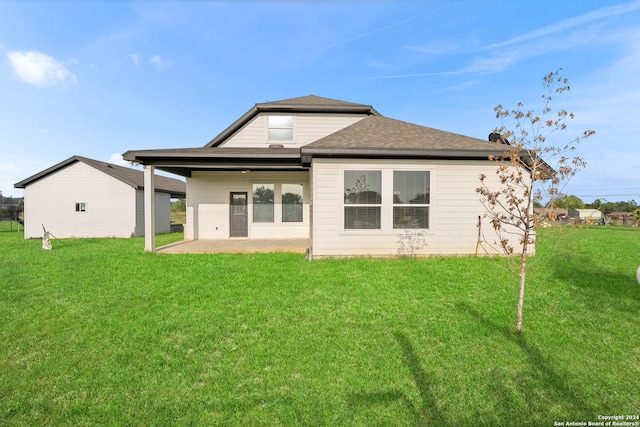 rear view of house with a patio area and a yard