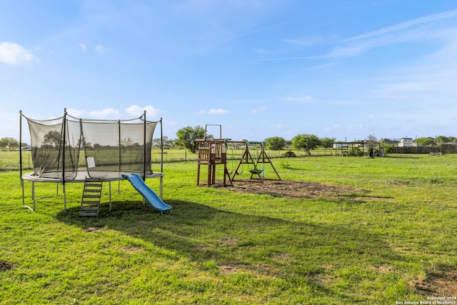 view of play area featuring a trampoline and a yard