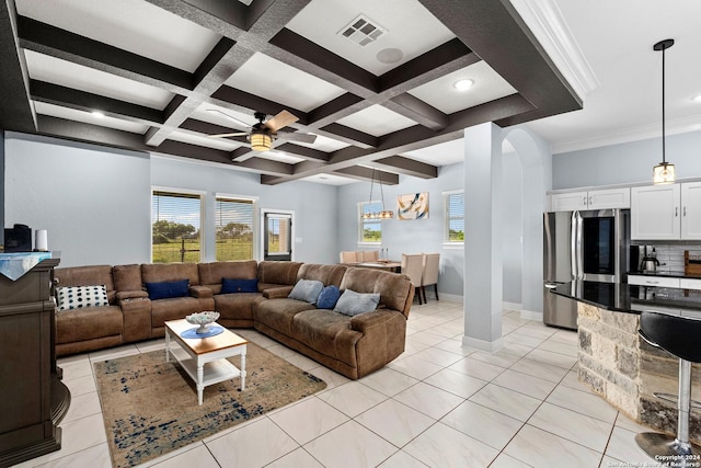 tiled living room with coffered ceiling, a wealth of natural light, ceiling fan, and beam ceiling