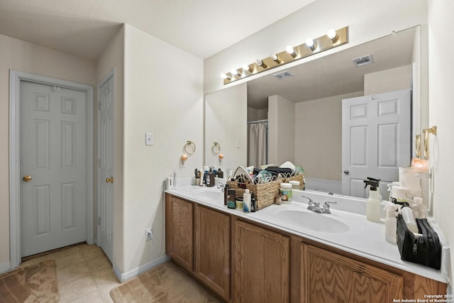 bathroom featuring dual vanity and tile patterned flooring