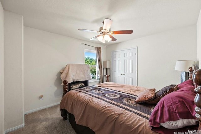 carpeted bedroom featuring ceiling fan and a closet