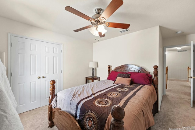 bedroom featuring light carpet, a closet, and ceiling fan