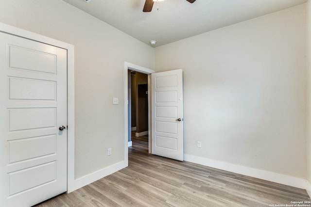 unfurnished bedroom with light hardwood / wood-style floors and ceiling fan