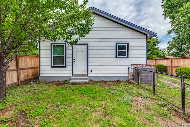 rear view of house with a lawn