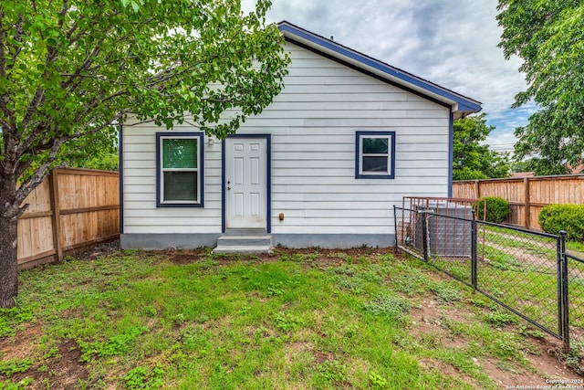 back of property featuring a lawn