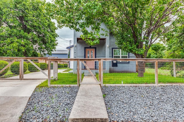 exterior space with a front lawn and french doors