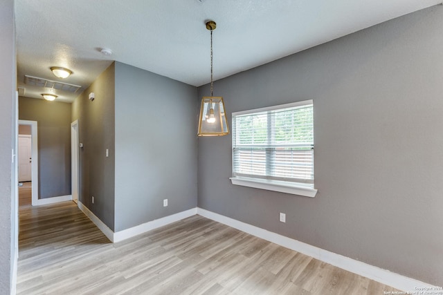 spare room featuring light wood-type flooring