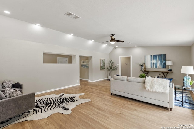 living room with light wood-type flooring, ceiling fan, and lofted ceiling