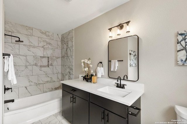 bathroom featuring vanity and tiled shower / bath