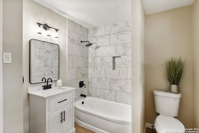 full bathroom with vanity, toilet, and tiled shower / bath