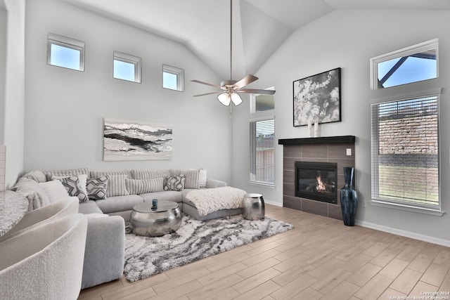 living room with a tile fireplace and plenty of natural light