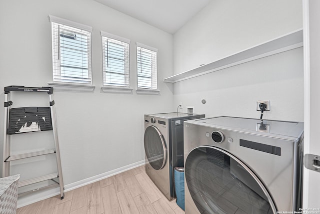 washroom featuring separate washer and dryer and light hardwood / wood-style flooring