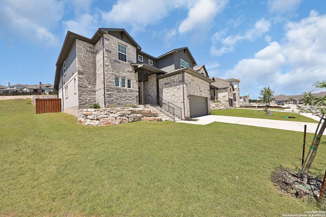 view of front of house featuring a front lawn and a garage