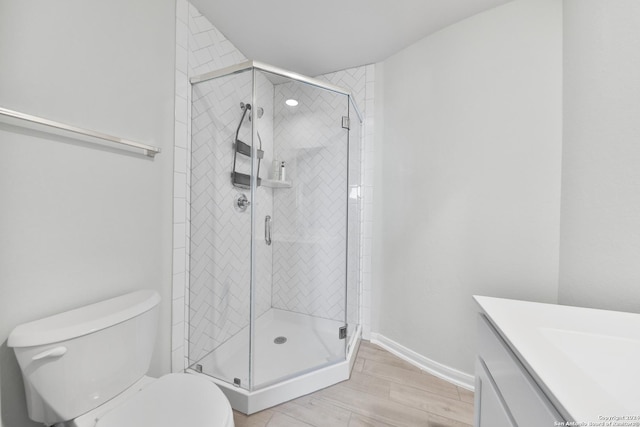 bathroom featuring walk in shower, vanity, and toilet