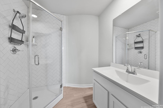 bathroom featuring vanity, hardwood / wood-style flooring, and an enclosed shower