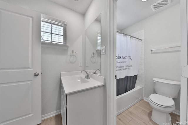 full bathroom with toilet, vanity, and shower / tub combo with curtain